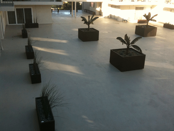 overhead view of rooftop deck lined with metal planters
