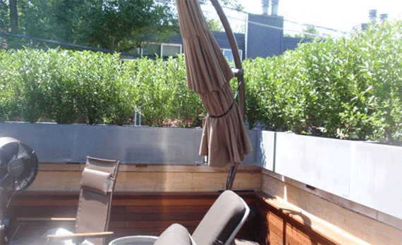 rooftop deck with aluminum metal planters used for privacy.