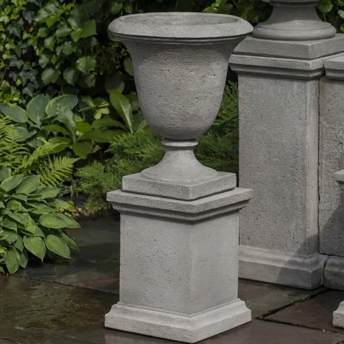 Linwood urn w/ low wolcott pedestal by campania international in cast stone, shown as an urn planter
