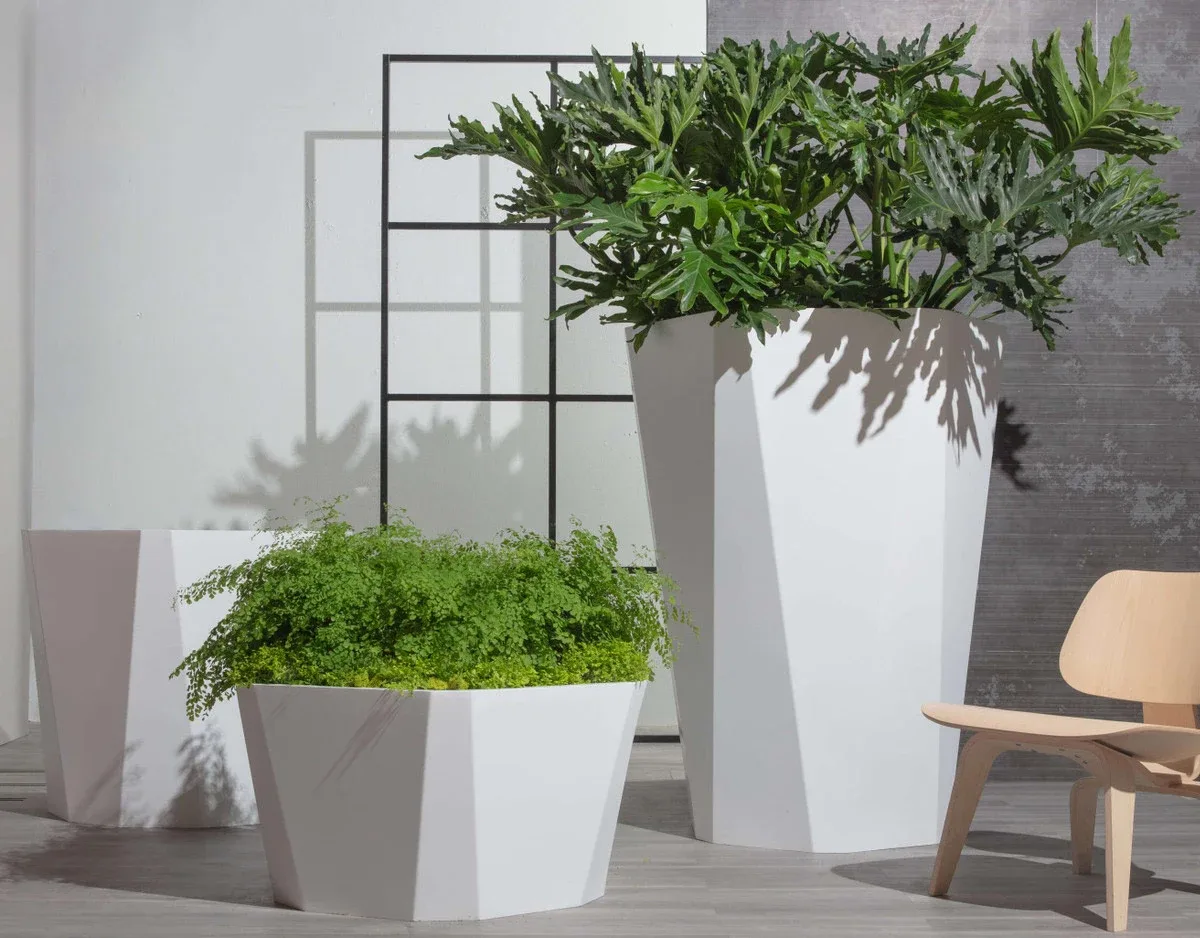 Metal-Planters-Vita-Brevis White metal planters arranged indoors