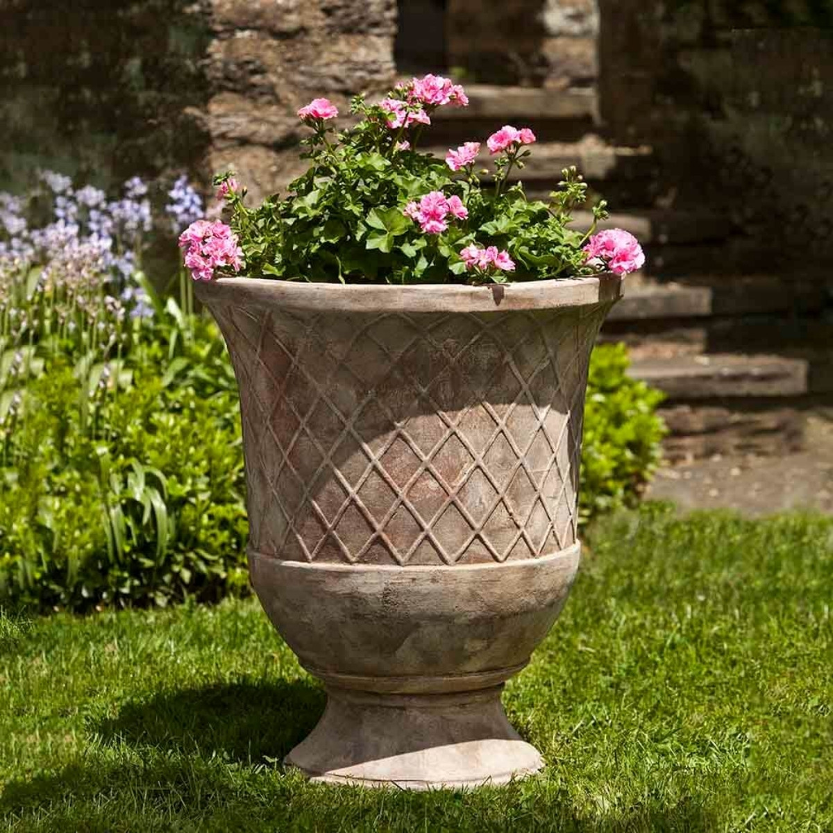 Campania international pomezio urns showing rounded vessel shape in terracotta for outdoor planting spaces
