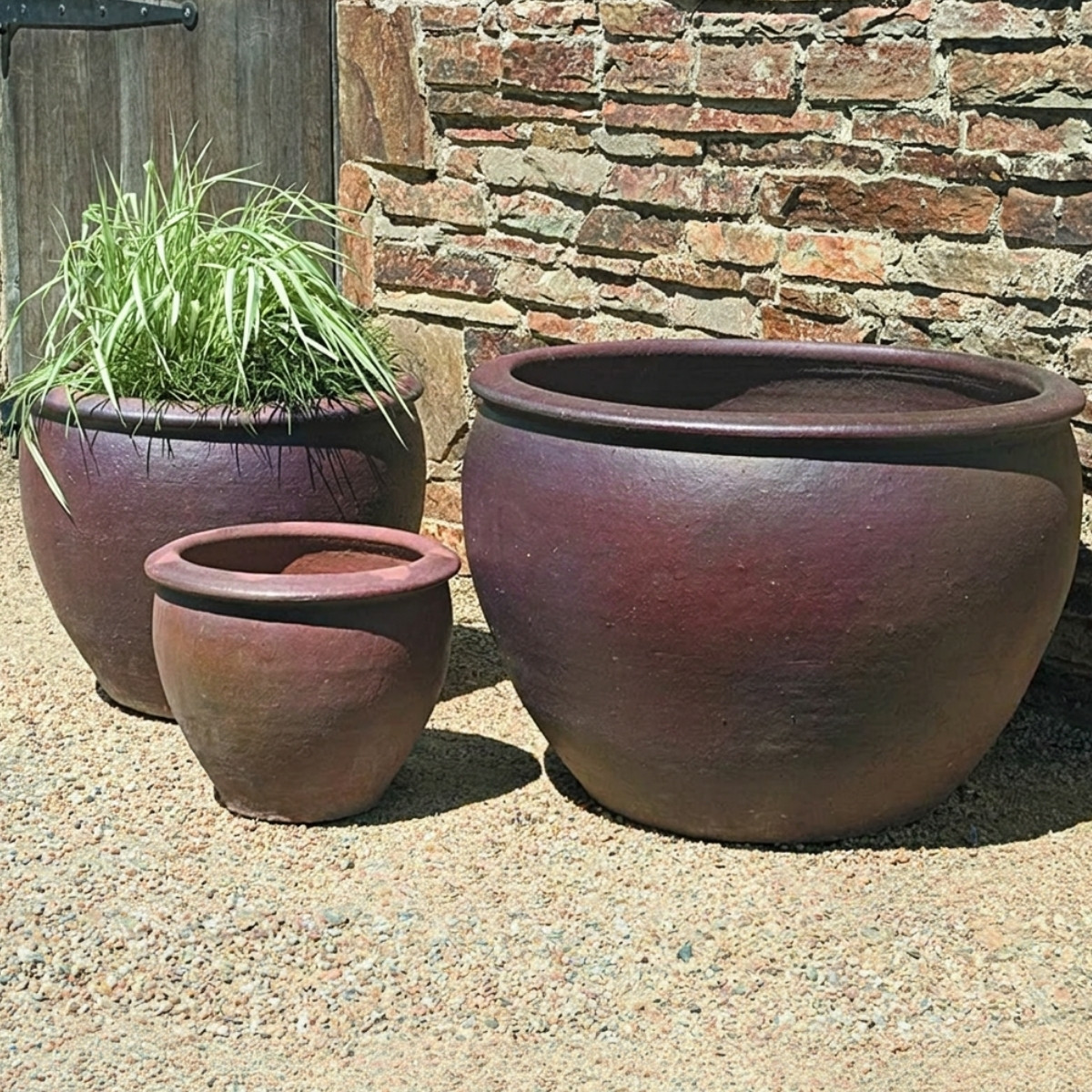 Tron cao pots in rich brown terracotta with three generous round forms and drainage holes