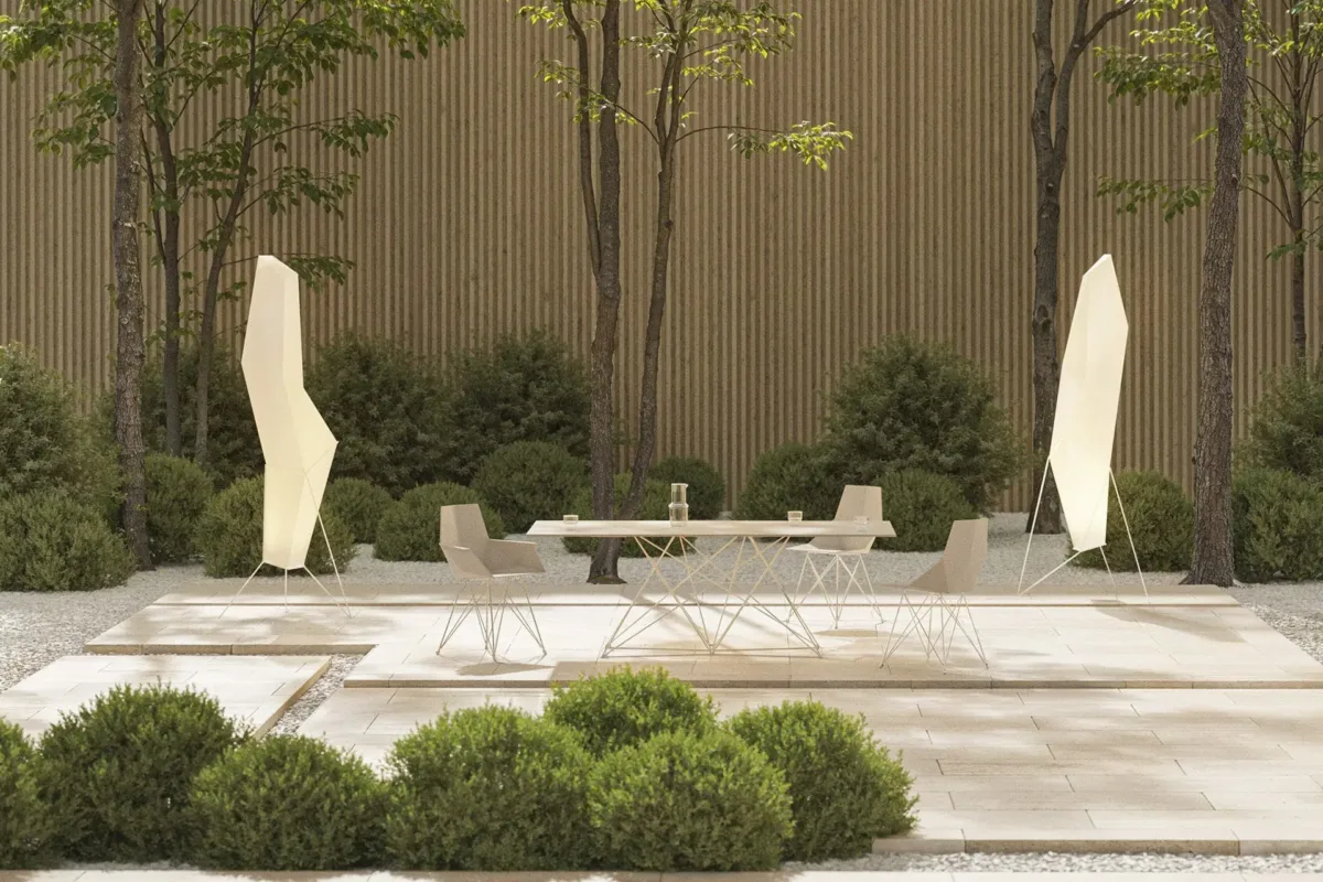 Vondom-Faz-Seating-with-Stainless-Steel-Legs Faz outdoor dining set with geometric table and chairs in a landscaped courtyard