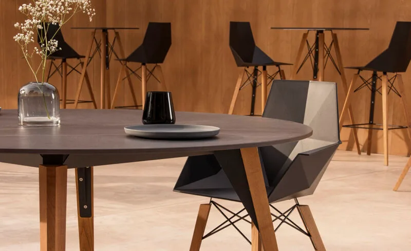 Vondom-Faz-Wood-Stool-Indoor-Dining Faz collection chair with wood legs beside a round dining table in a modern interior