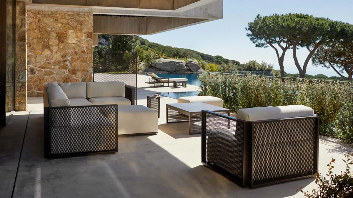 Vondom-The Factory-Modular-Seating-Systems Contemporary outdoor lounge seating with structured mesh panels on a stone terrace overlooking the sea