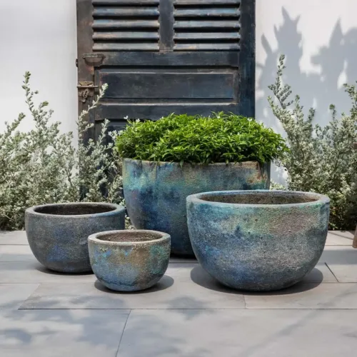 Blue verdigris bowl planters set displayed on a modern outdoor patio